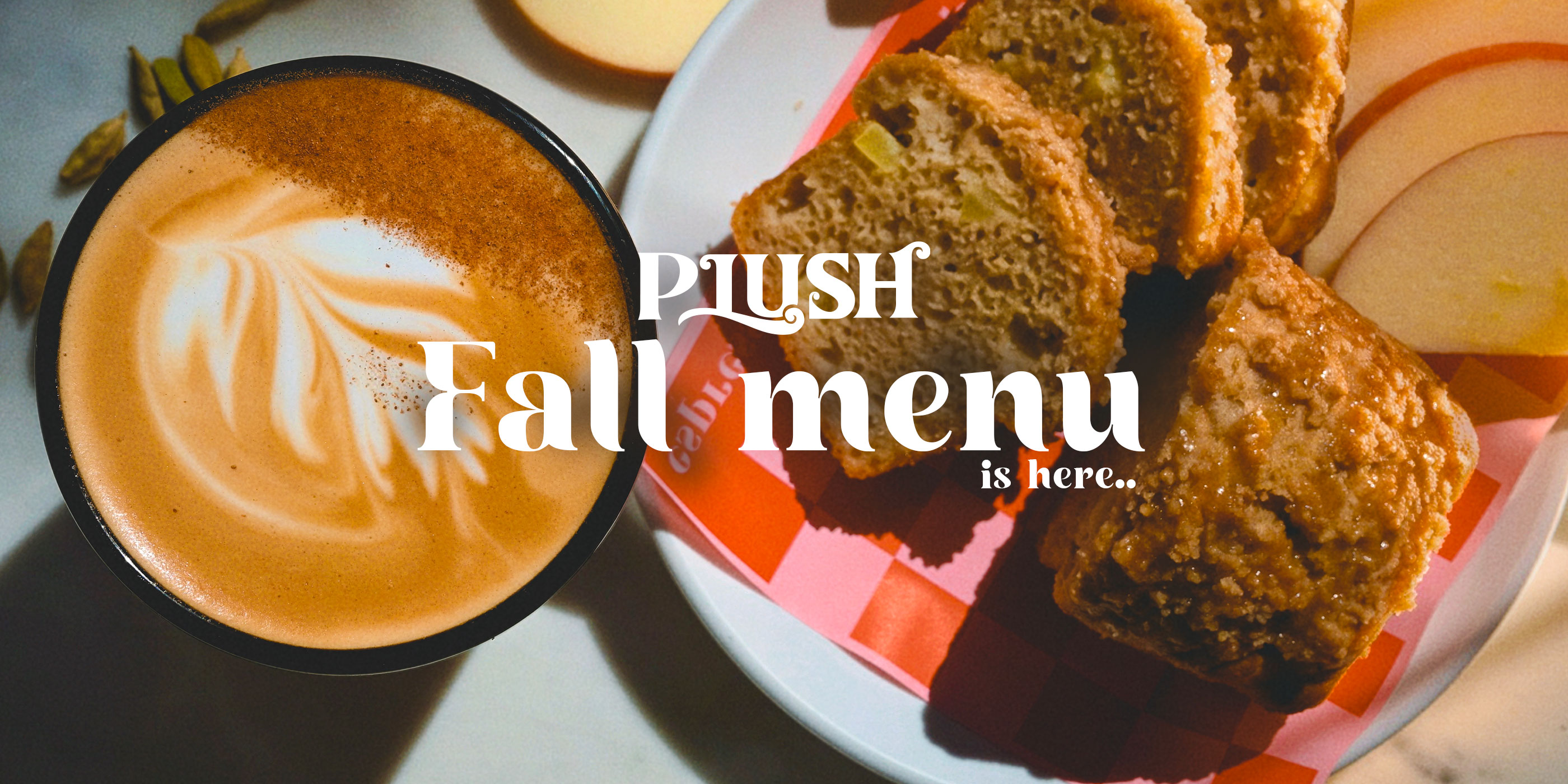 Plush fall menu is here: cinnamon-dusted latte beside slices of apple crumb bread
